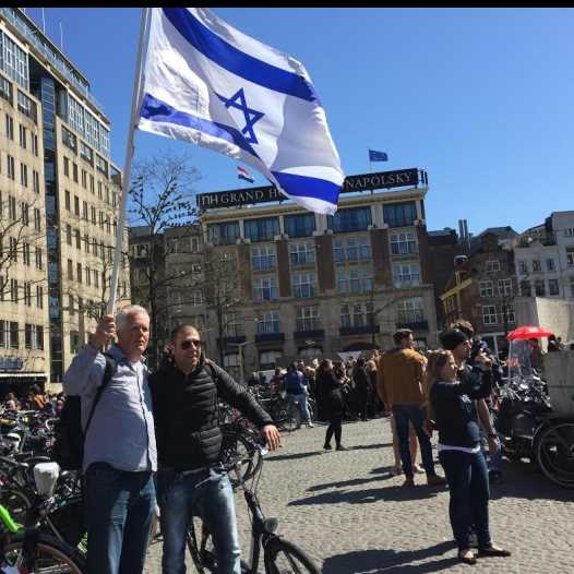 Pastor Stan Kamps waving the Israeli flag in Amsterdam as part of a campaign to fight anti-Semitism in Europe and show solidarity with European Jewry