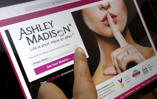 The homepage of the Ashley Madison website is displayed on an iPad, in this photo illustration