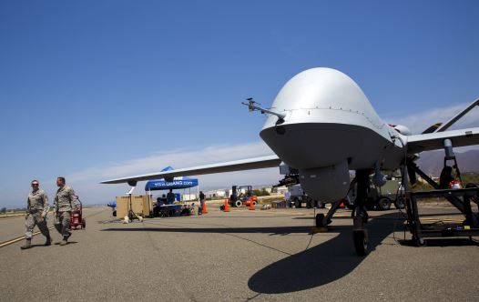 A General Atomics MQ-9 Reaper stands on the runway during ''Black Dart'', a live-fly, live fire demonstration of 55 unmanned aerial vehicles