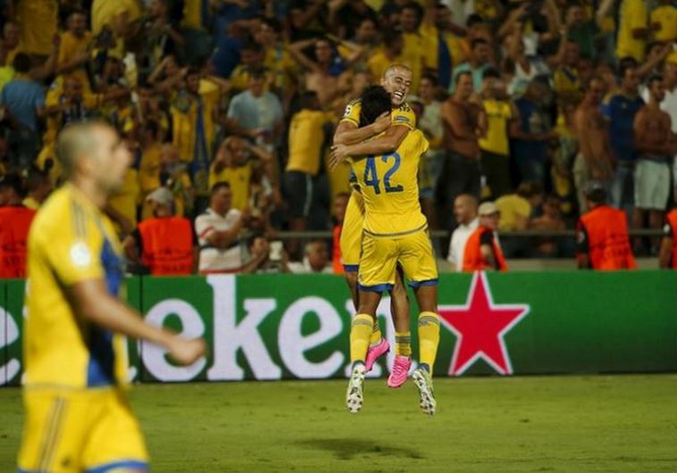 Maccabi Tel Aviv's Dor Peretz and Tal Ben Haim celebrate after advancing to the group stages of Champions League