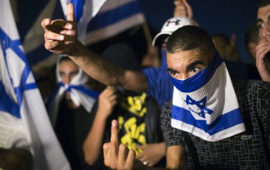 A right-wing Israeli activist gestures during a counter-protest against supporters of hunger-striking Palestinian detainee Mohammed Allan