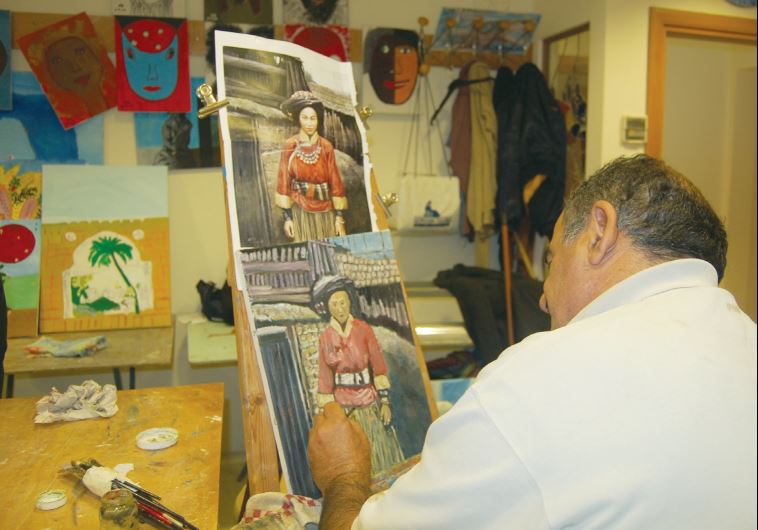 A man participate in an social art club offered by NATAL at its center in Tel Aviv.
