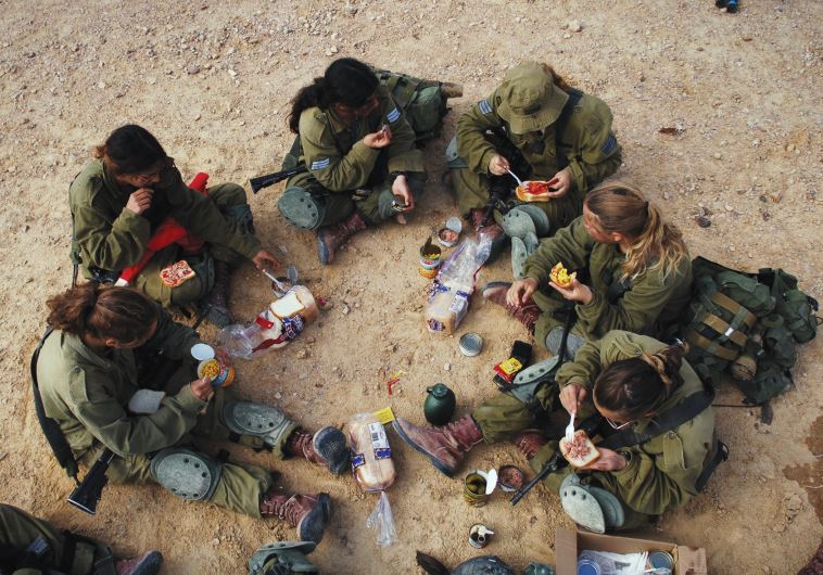 SOLDIERS SIT for a shared meal during training. IDF regulations are supposed to favor lone soldiers in giving them extra time to complete errands outside the army, but some say that this is not being honored.