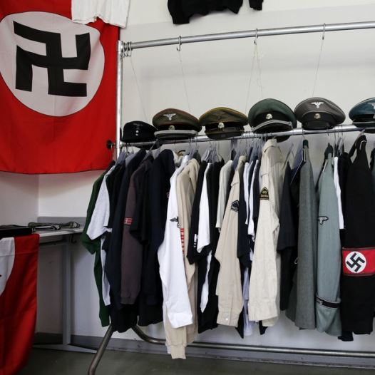 Nazi uniforms and a Swastika flag that were confiscated by the Berlin police during raids against German neo-Nazis