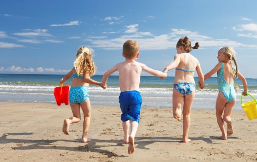 Children on beach vacation (illustrative)