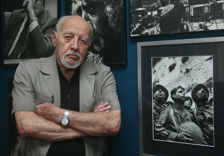 David Rubinger at home, flanked by some of his most iconic photos – including, of course, the June 7, 1967, shot of the three paratroopers at the newly liberated Western Wall