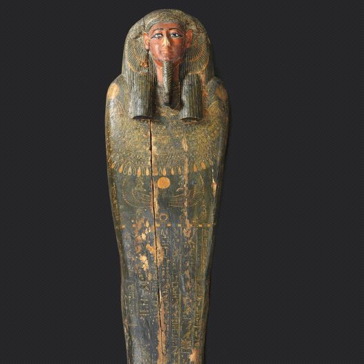 The lid of the mummy’s coffin sports characteristic ancient Egyptian stylized facial features and informative hieroglyphics