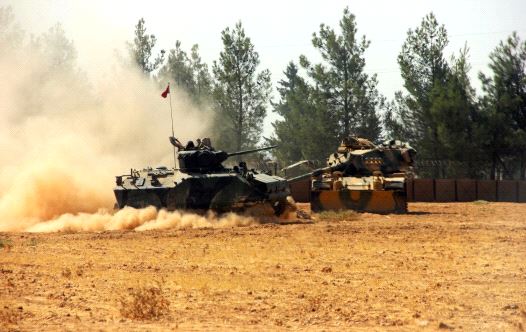 A Turkish army tank and an armoured vehicle are stationed near the Turkish-Syrian border in Karkamis in the southeastern Gaziantep province, Turkey, August 23, 2016