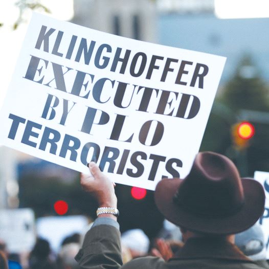 A PROTESTER holds up a sign condemning the Palestine Liberation Organization for the murder of Leon Klinghoffer