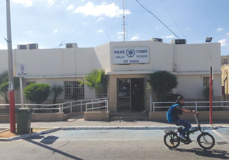 AN OFFICER stands in the doorway of the Israel Police station in Lod.