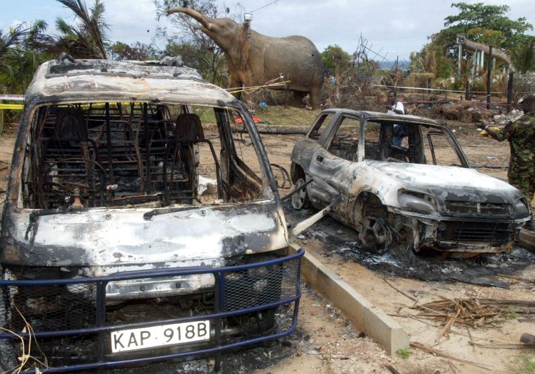 BURNED CARS ARE SEEN IN THE GROUNDS OF THE PARADISE HOTEL IN MOMBASA.