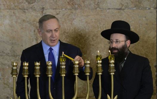 Prime Minister Benjamin Netanyahu Lighting Hanukkah candles at the Kotel