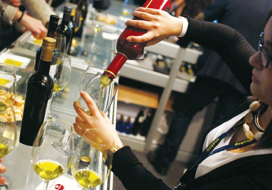 A woman serves olive oil during the Madrid Fusion 13th International Summit of Gastronomy in Madrid, two years ago