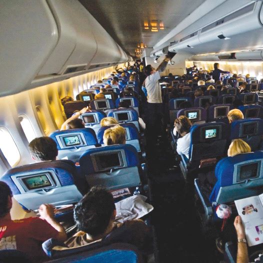 Passengers sitting inside an airplane [illustrative]