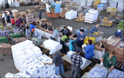 Volunteers put together food packages ahead of the Passover holiday at the Colel Chabad main packaging facility in Kiryat MalachiVolunteers put together food packages ahead of the Passover holiday at the Colel Chabad main packaging facility in Kiryat Malachi