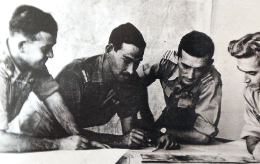 Harold ‘Smoky’ Simon (second left, inset) goes over plans with then-Israel Air Force commander Aharon Remez (left) and two unidentified serviceman during the War of Independence.