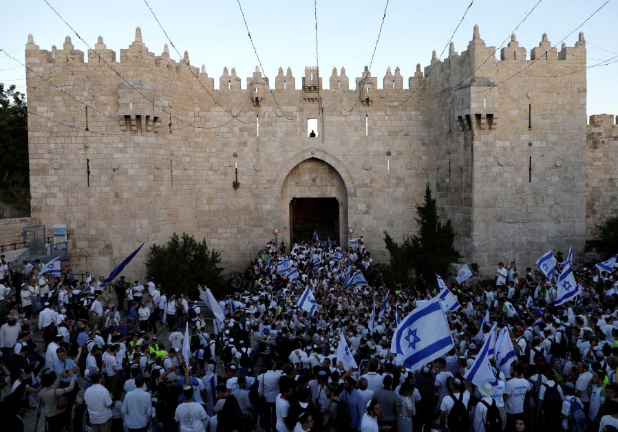 Israelis celebrate as they hold Israeli flags during a parade marking Jerusalem Day, the day in the Jewish calendar when Israel captured East Jerusalem and the Old City from Jordan during the 1967 Middle East War, just outside Damascus Gate outside Jerusalem's Old City May 24, 2017.