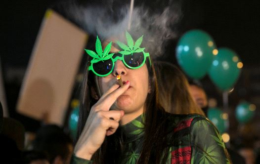 A woman smokes during an event marking Israel's government's approval of a new policy to decriminalize personal marijuana use in Tel Aviv, Israel February 4, 2017