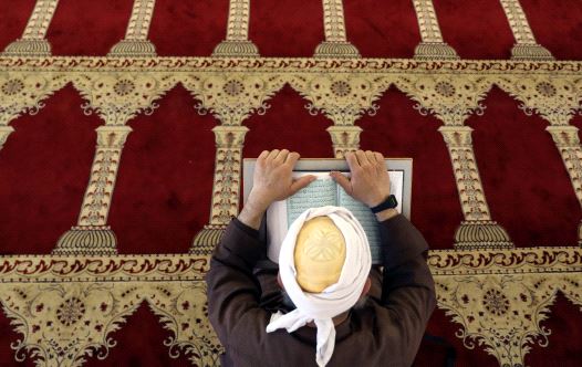 A Palestinian man reads the Koran in al-Aqsa Mosque in Jerusalem's Old City during the holy month of Ramadan