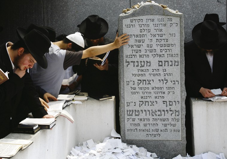 Followers of the late Rabbi Menachem Mendel Schneerson pray at his grave at the Old Montefiore Cemetery in the Queens section of New York city.