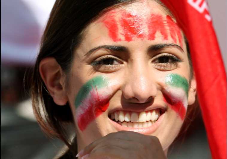 A woman, cheering on Iran's team, smiles while attending a soccer match in Nuremberg, Germany 