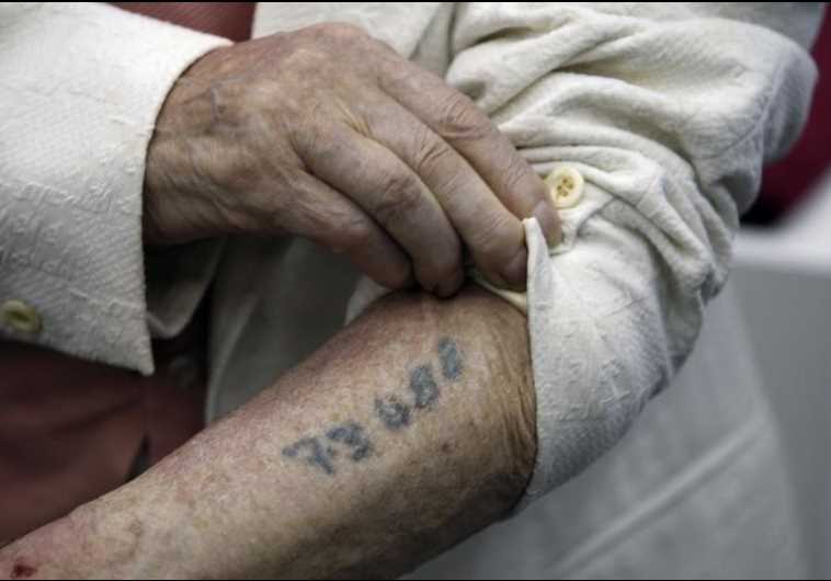 A Holocaust survivor shows his prisoner number tattooed on his arm, Yad Vashem, Jerusalem