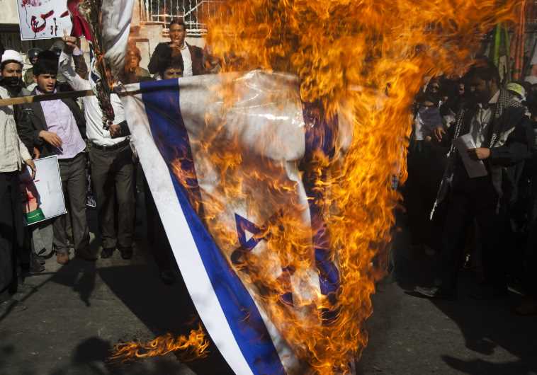 Iranian students burn Israeli flag.
