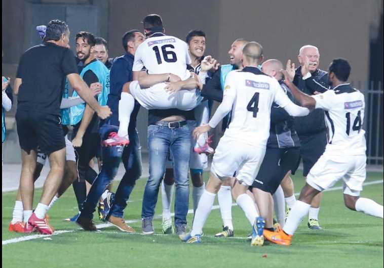 Hapoel Acre players and staff celebrated wildly after Elior Cider scored the team’s winner in Saturday night’s 1-0 victory over Hapoel Haifa