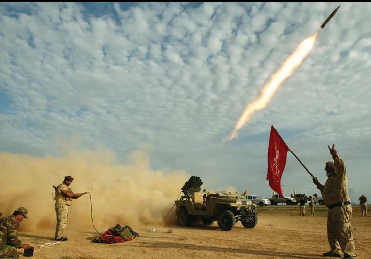 SHI’ITE FIGHTERS launch a rocket last month during clashes with Islamic State on the outskirts of al-Alam, Iraq.