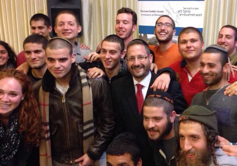Former MK Dov Lipman with lone soldiers at a Thanksgiving dinner arranged by the Lone Soldier Center.