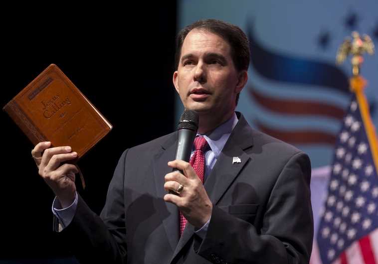 Governor of Wisconsin and potential Republican U.S. Presidential candidate Scott Walker refers to the book "Jesus Calling" at the Iowa Faith and Freedom Coalition's forum in Waukee, Iowa