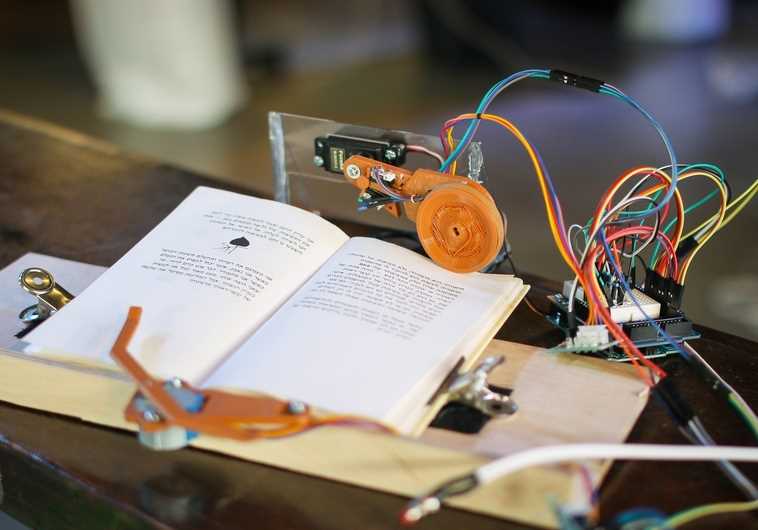 This system developed at a Tikkun Olam Makers (TOM) "make-a-thon" allows people who are paralyzed from the neck down to turn pages in a book.