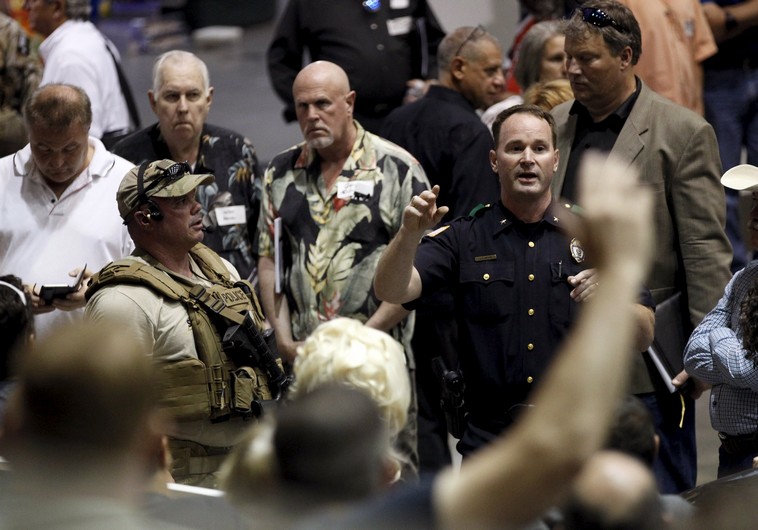  A police officer seeks witnesses to the shooting outside of the Muhammad Art Exhibit and Contest sponsored by the American Freedom Defense Initiative in Garland, Texas
