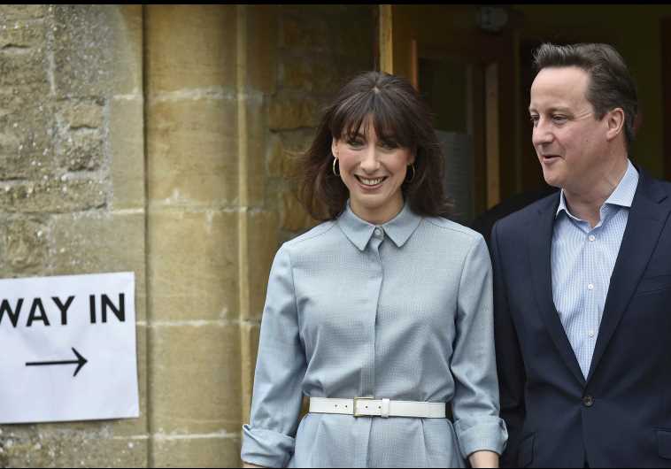 Britain's Prime Minister David Cameron and his wife Samantha leave after voting in Spelsbury, central England, May 7