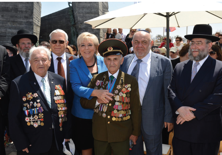 NETANYA MAYOR Miriam Feirberg Ikar stands with World War II Jewish veterans at a ceremony to mark 70 years since VE Day in the coastal city on Wednesday.