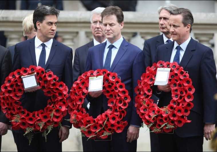 Ed Miliband (L) who resigned as leader of the Labour Party, Nick Clegg who resigned as leader of the Liberal Democrats, and Britain's Prime Minister David Cameron (R) carry wreaths of poppies as they pay tribute at the Cenotaph to mark the 70th anniversary of VE Day in London