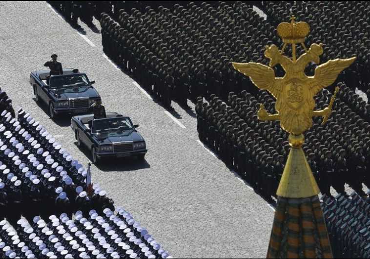 Russian Defense Minister Sergei Shoigu (standing in the first car) and Colonel-General Oleg Salyukov (second car, standing), Russia's Army Commander and Victory Parade Commander review troops at the beginning of the Victory Day parade at Red Square in Moscow