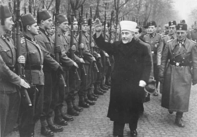 Nakba instigator Husseini giving the Heil Hitler salute to Bosnian Muslim volunteers to the notorious Waffen SS (the Hanzar SS Division) in November, 1943 [Jerusalem Post Archives]   
