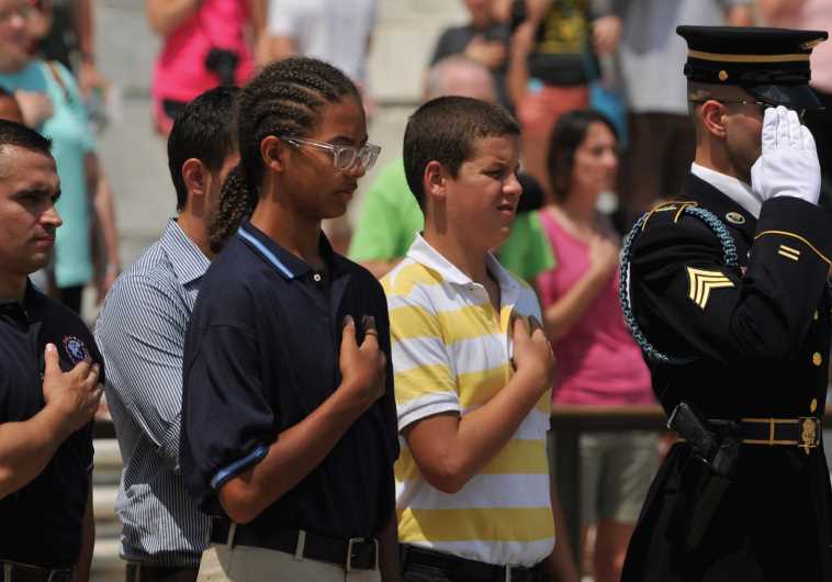 Children participate in the wreath-laying ceremony at Arlington National Cemetery.