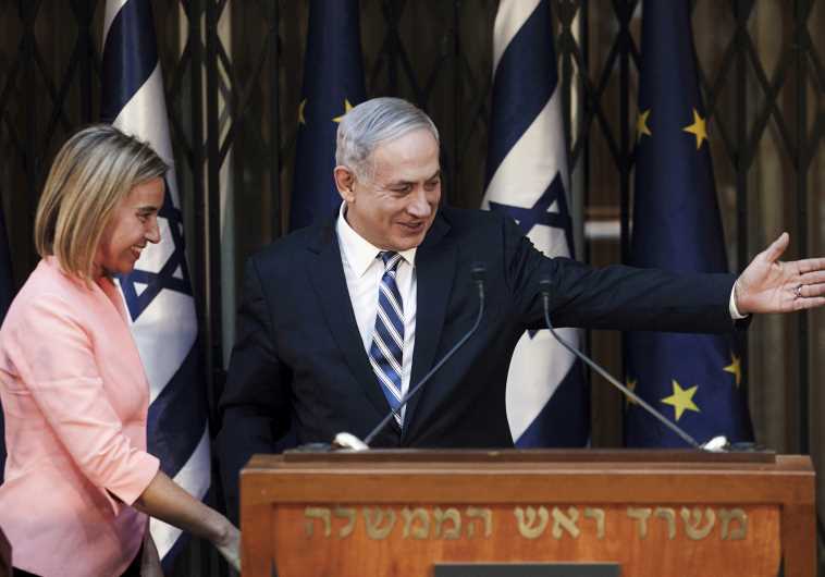 Prime Minister Benjamin Netanyahu (R) shows the way to European Union foreign policy chief Federica Mogherini