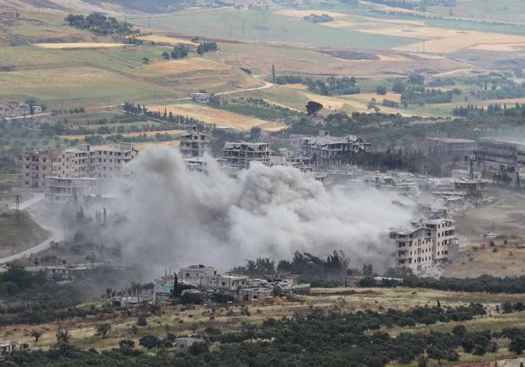 Smoke rises from buildings near the national hospital, after what activists said was shelling by warplanes loyal to Syria's President Bashar al-Assad in the town of Jisr al-Shughour, Idlib province May 22, 2015
