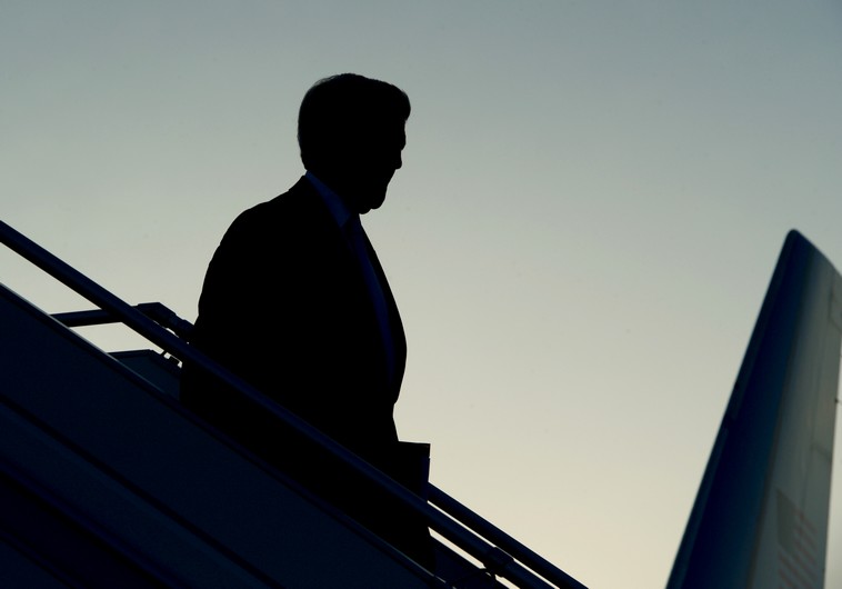 US Secretary of State John Kerry is seen in silhouette as he deplanes against an evening sky after arriving in Geneva, Switzerland, on May 29, 2015