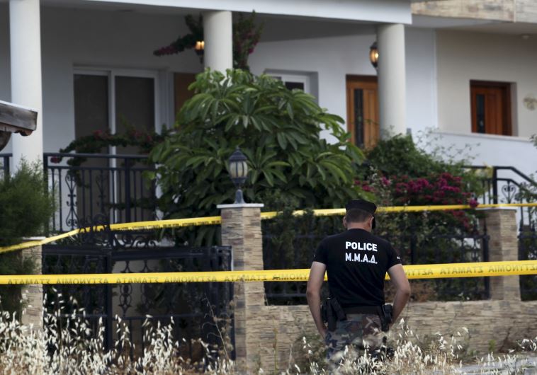 A policeman stands guard at a house where police discovered almost two tons of ammonium nitrate in Larnaca, Cyprus