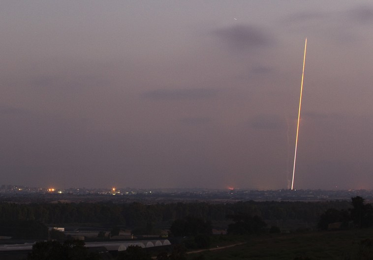 Light streak trail is seen as a rocket is launched from the northern Gaza Strip towards Israel July 29, 2014