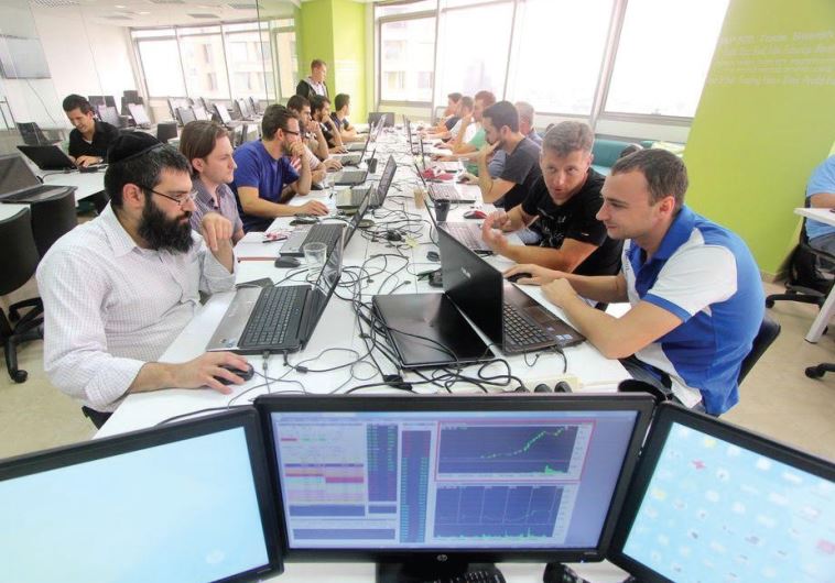 A haredi man trades stocks in Simple Trade’s shared workspace in Ramat Gan