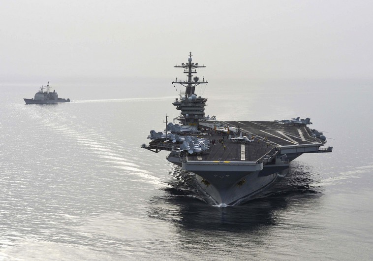 The aircraft carrier USS Theodore Roosevelt (CVN 71) and the guided-missile cruiser USS Normandy (CG) 60 sail in the Arabian Sea, in this US Navy photo taken April 16, 2015