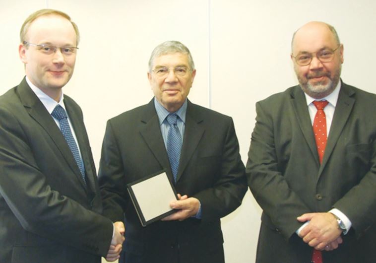 LUKASZ KAMINSKI (from left), president of the Institute of National Remembrance – Commission for the Prosecution of Crimes against the Polish Nation; Avner Shalev, chairman of the Holocaust Martyrs’ and Heroes’ Remembrance Authority Directorate; and Polish Ambassador Jacek Chodorowicz meet at Yad Va