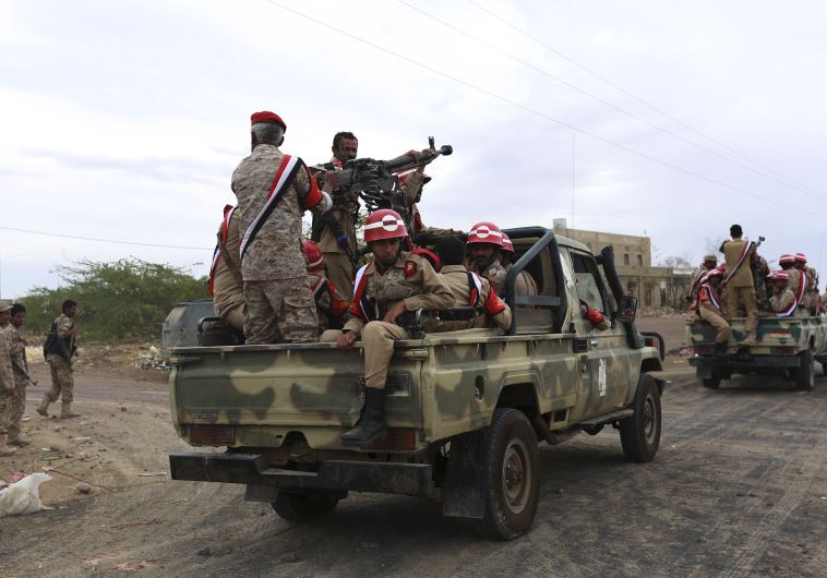 Soldiers loyal to Yemen's President Abd-Rabbu Mansour Hadi ride at the back of a pick-up truck during a parade in Yemen's northern province of Marib