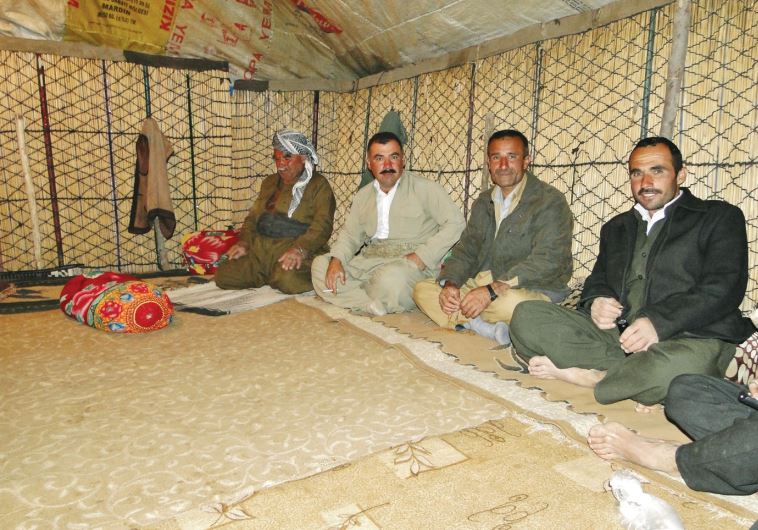 Kurdish nomads sit in a tent on Mount Halgurd, near the border with Iran border.