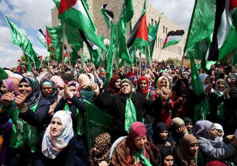 Palestinians supporting Hamas chant slogans during a rally celebrating Hamas student supporters winning the student council election at Birzeit University in Ramallah